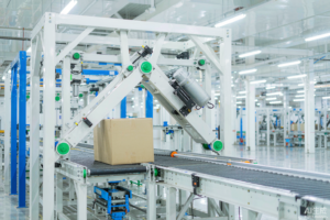 Swing arm sorter diverting a heavy carton to a side lane on a warehouse conveyor
